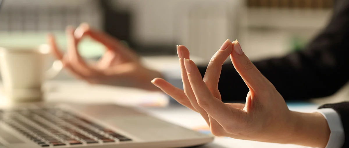 Hands of an office worker, meditating in the office.
